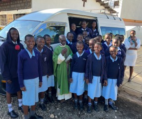 smiling girls in front of white van